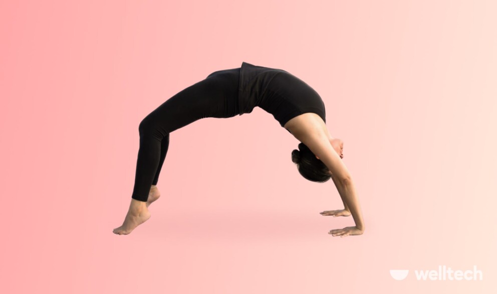 a woman is performing Wheel Pose_yoga arm balances