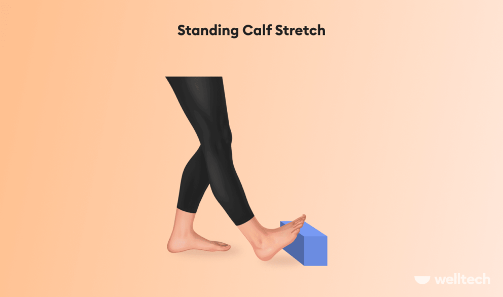 performing standing calf stretch using yoga block_ankle mobility exercises