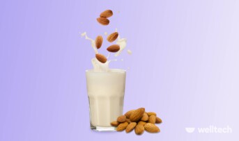 a glass of almond milk with somw almonds falling into it_carbs in almond milk