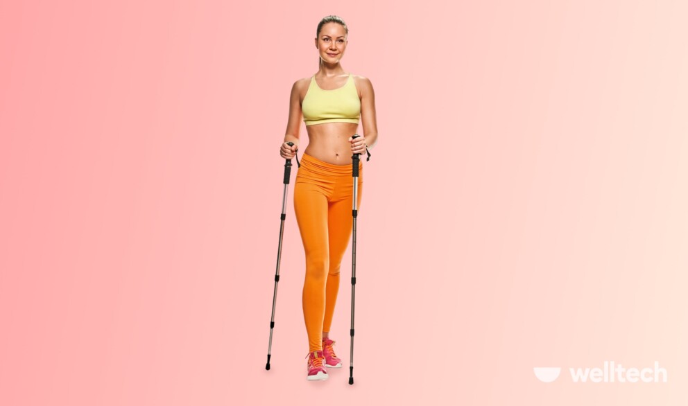 a girl in sportswear is walking with poles_walking with sticks benefits