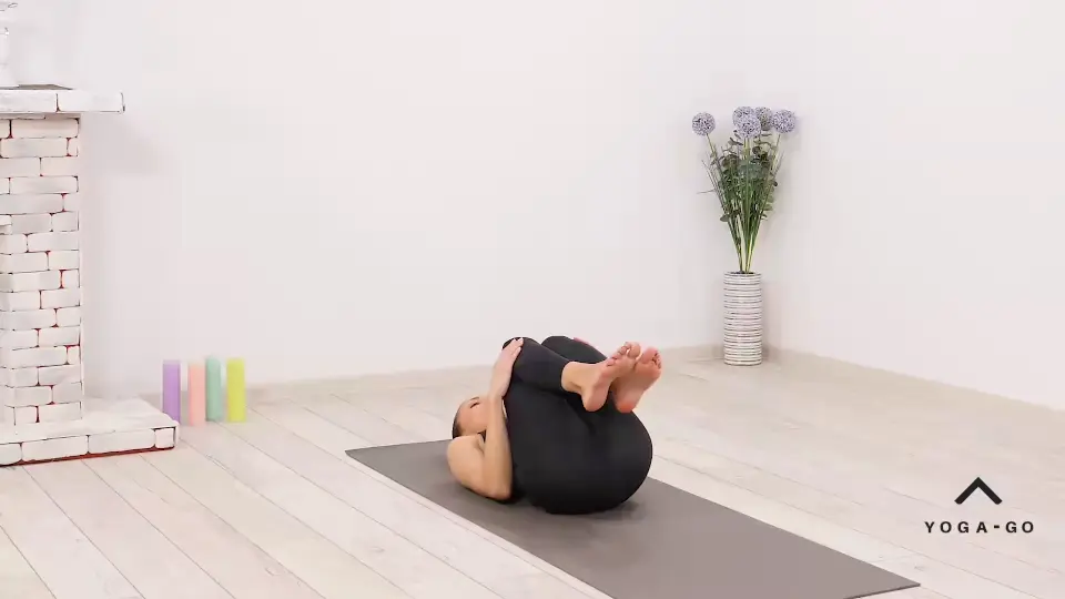 a woman is practicing Half Plow Pose_Ardha Halasana_cool down yoga