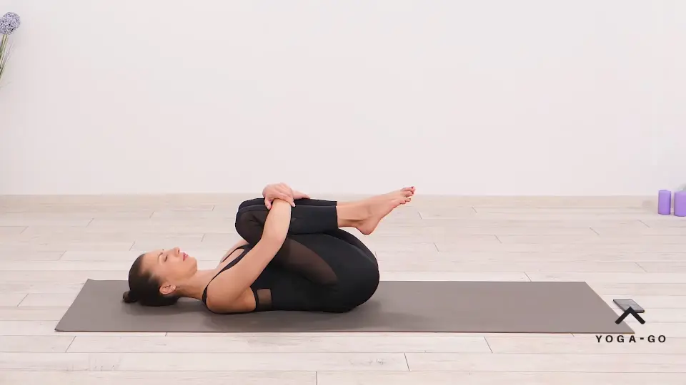 a woman is practicing Happy Baby Pose_Ananda Balasana_cool down yoga