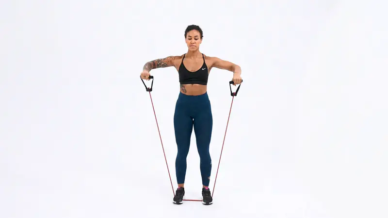 a woman is performing scarecrows_chest and tricep workout for women