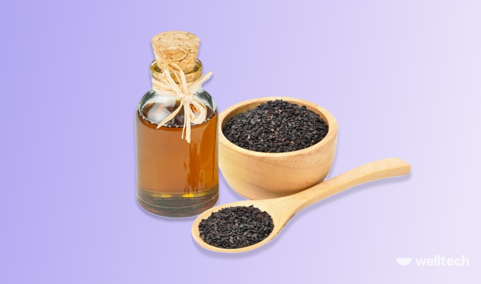 a bottle of black seed oil with a bowl of black seeds near it_black seed oil weight loss