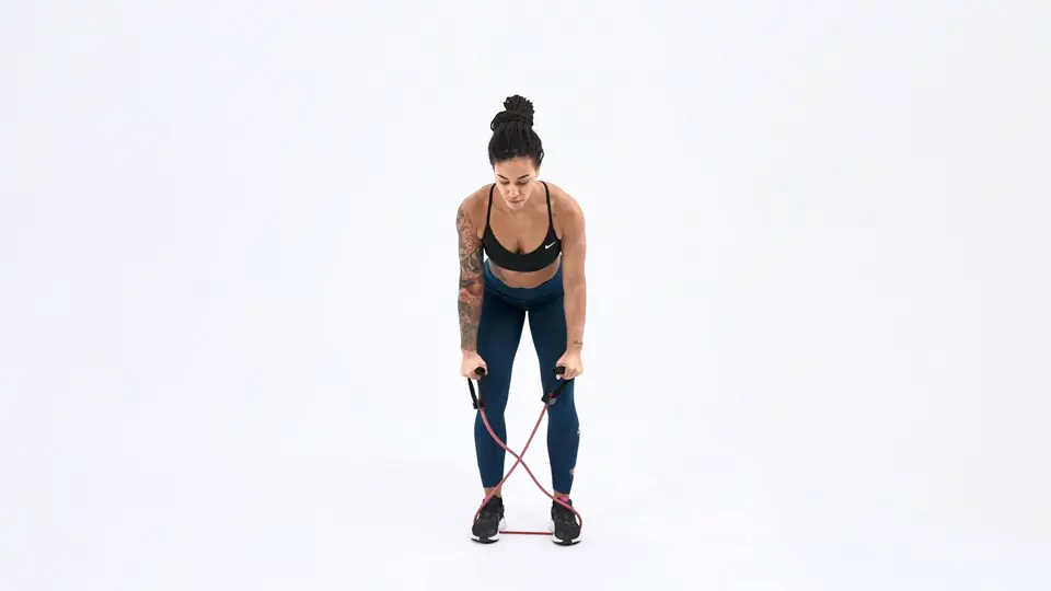 a woman is performing Rear Delt Raises with a handle resistance band_bra back fat