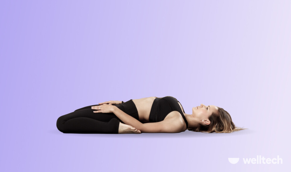 a woman is practicing Saddle Pose (Supta Virasana)_hip flexor stretch yoga