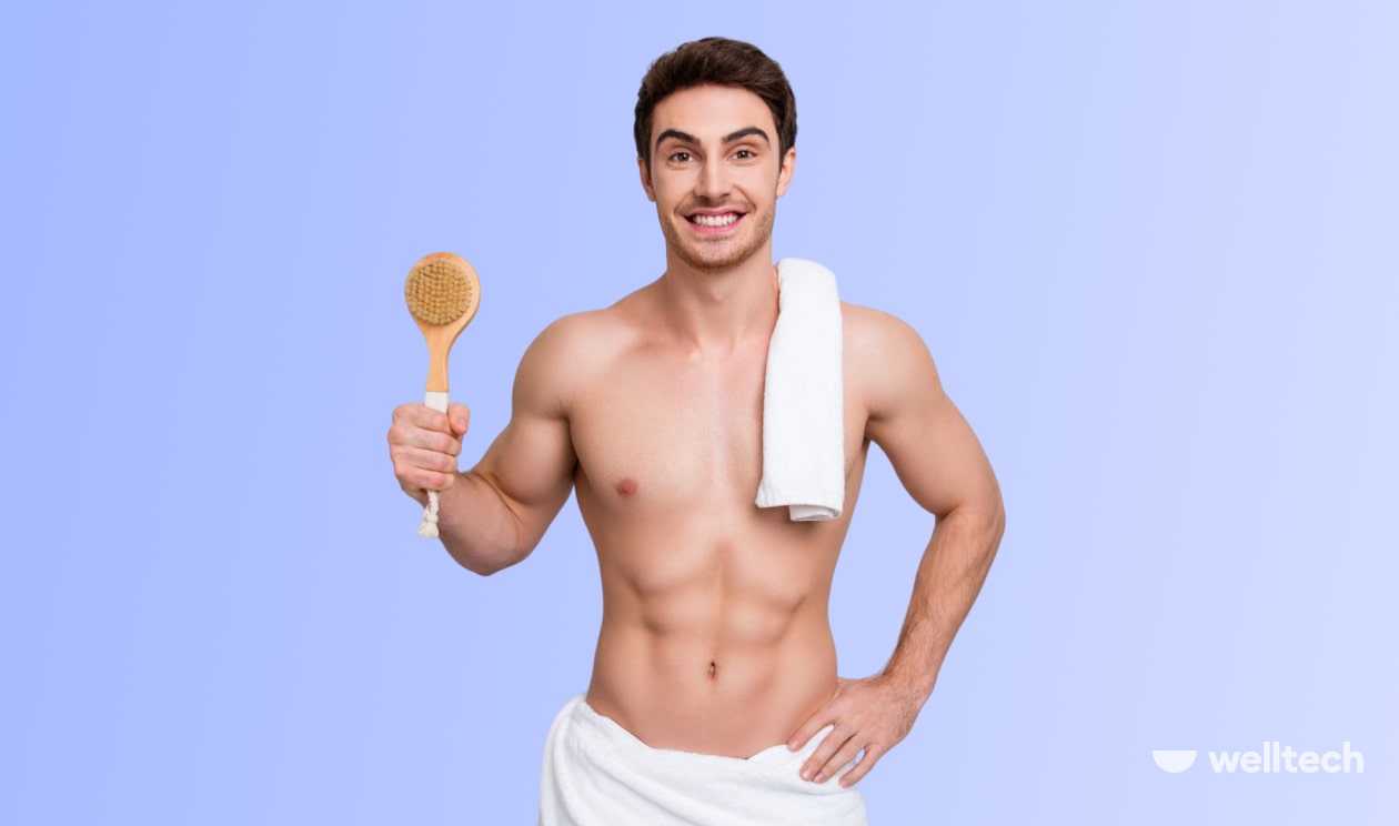 a man is preparing for sauna, smiling, holding a towel and a dry brush_sauna before or after workout