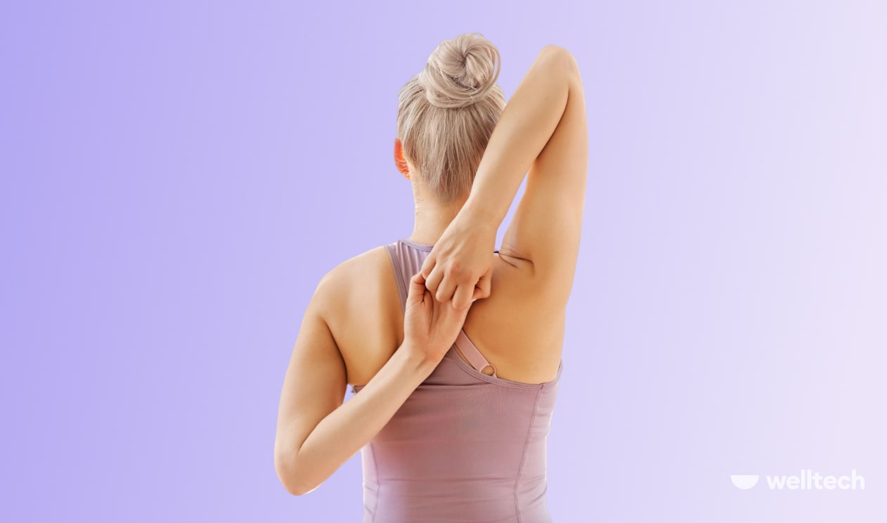 a woman is practicing Cow Face Pose, sitting with her back_shoulder yoga poses