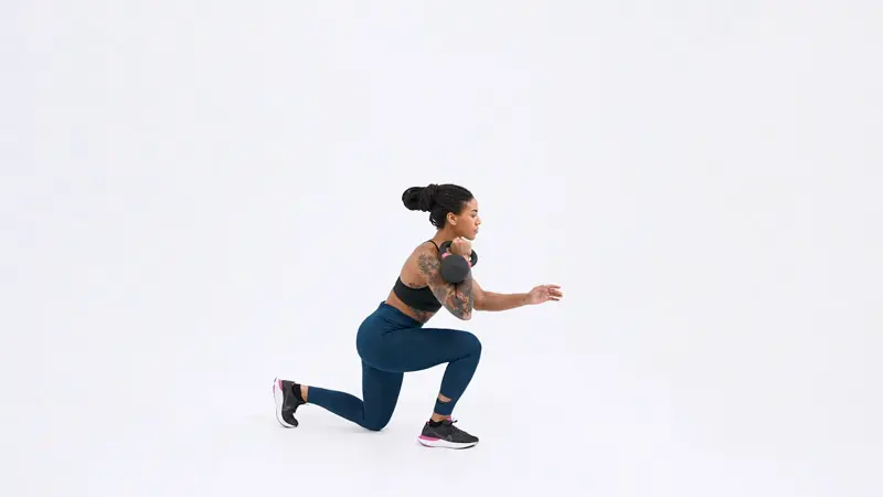 a woman is performing Reverse lunge knee up with a kettlebell_box jump alternative