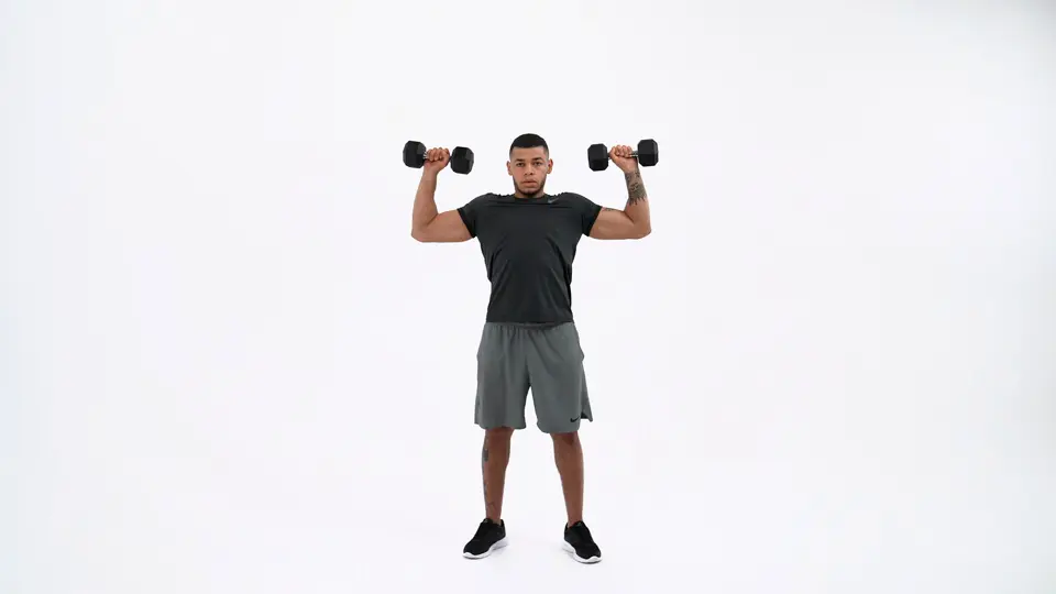 a man is performing Standing Shoulder Press_dumbbell push workouts