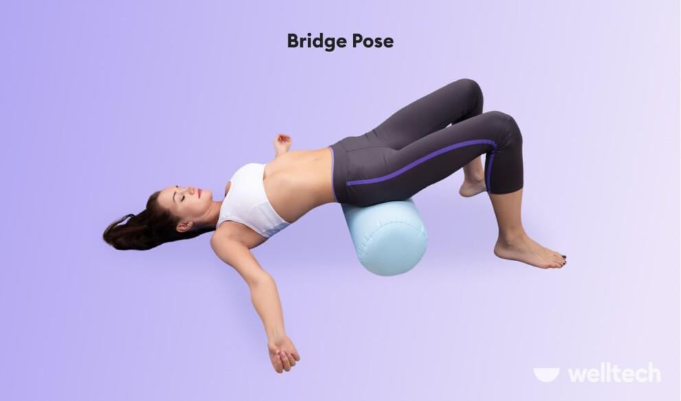 a woman is practicing restorative yoga_bridge pose__yoga poses with a bolster