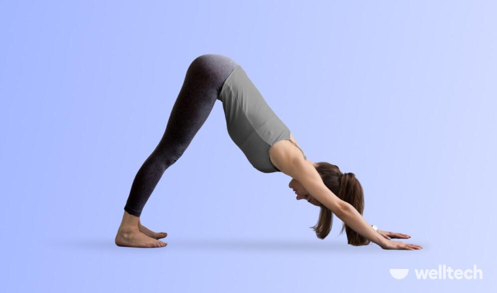 a woman is practicing yoga, doing Downward Facing Dog (Adho Mukha Svanasana)_yoga inversions