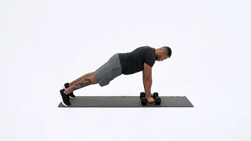 a man is performing Plank Dumbbell Row, pull exercises