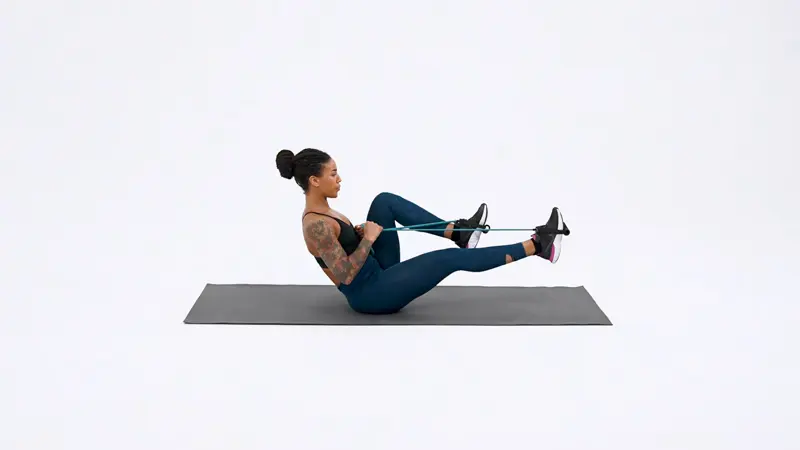 a woman is performing Bicycle_Kick_With_Ab_Hold_ab exercises that don’t hurt lower back