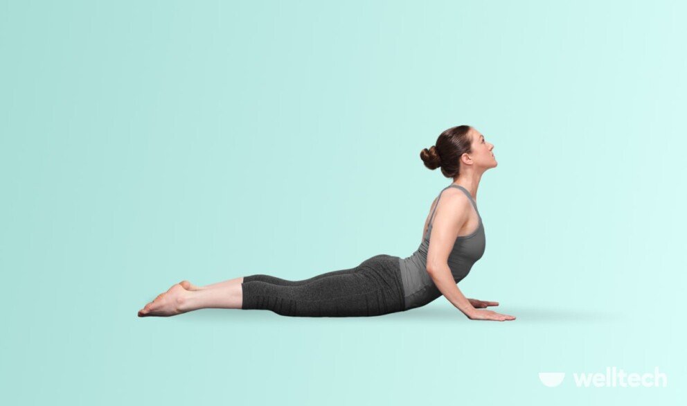 a woman is practicing yoga, doing Cobra Pose (Bhujangasana)_yoga for belly fat