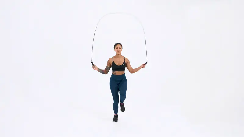 a woman is doing plyometrics, Jumping_Rope_High_Knee_plyometric exercises for speed