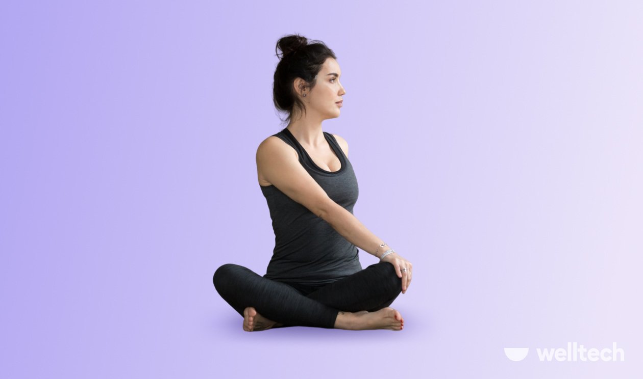 a woman is practicing yoga, doing Revolved Easy Pose_seated yoga poses