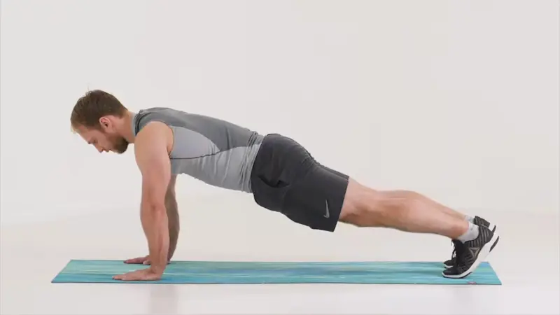 a man is performing high plank_ab exercises that don’t hurt lower back