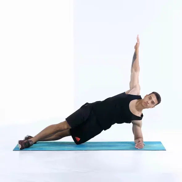 a man is performing plank reach through_ab exercises that don't hurt lower back