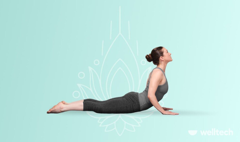 a woman is doing cobra pose, yoga for belly fat