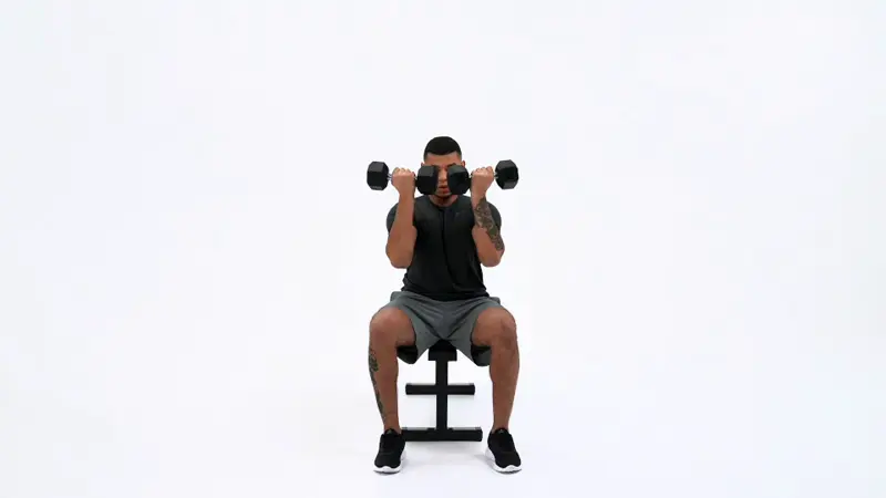 a man is performing Dumbbell Arnold Presses_side delt exercises