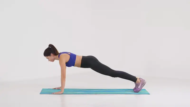 a woman is performing push-ups_breast-firming exercises
