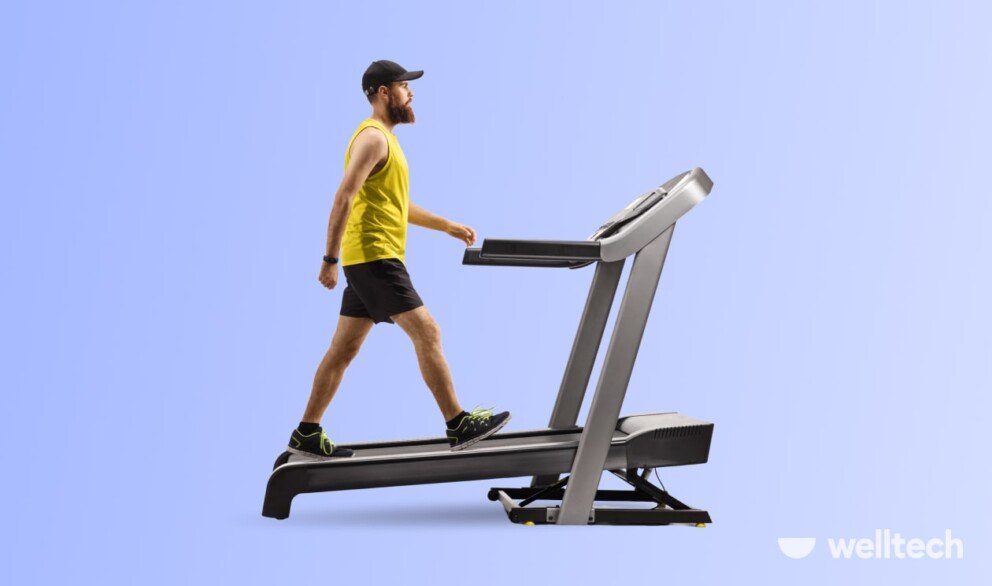 a man is walking on a treadmill with an incline, benefits of walking on a treadmill