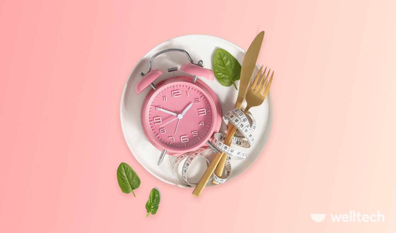 a clock is laying on a plate with utensils and a measure tape, intermittent fasting rules