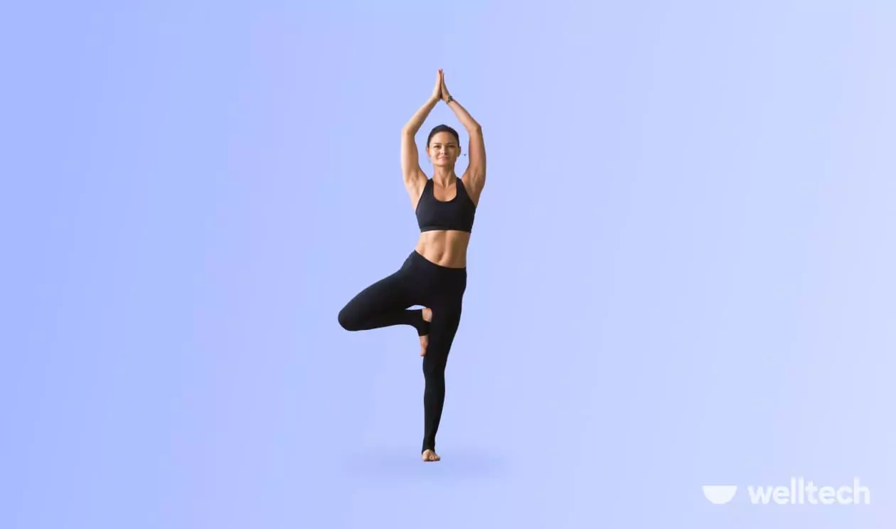 a woman is doing yoga, practicing Tree Pose (Vrksasana)_standing yoga poses