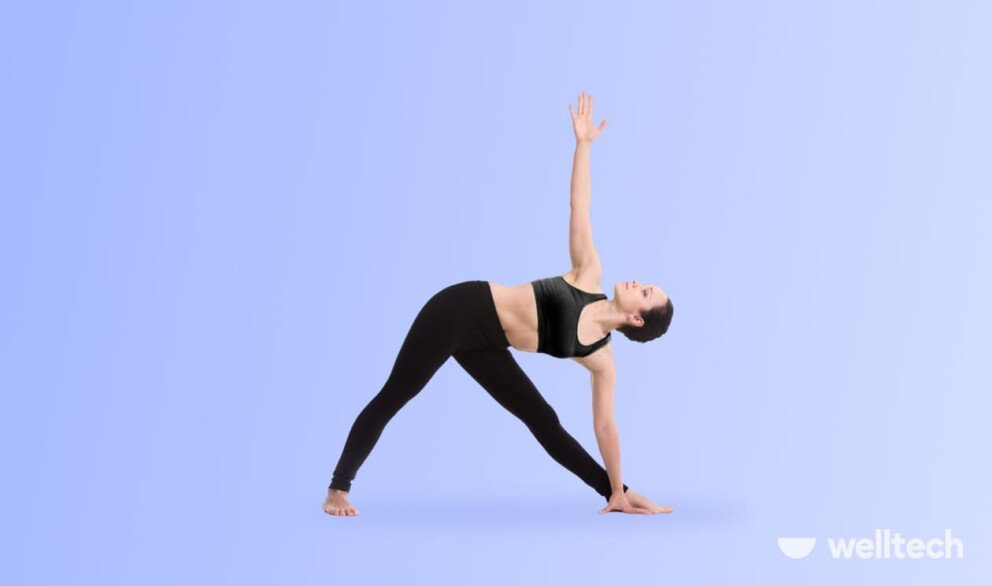 a woman is doing yoga, practicing Triangle Pose (Trikonasana)_standing yoga poses