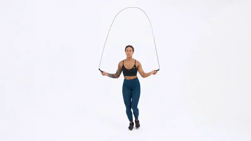 a woman is doing jump rope one leg hop_knee fat exercises