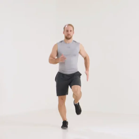 a man is doing running in place_leg day warm up