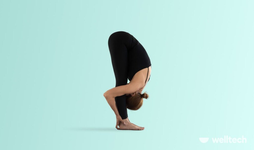 a woman is practicing yoga, doing Standing Forward Fold (Uttanasana)_yoga poses relaxing