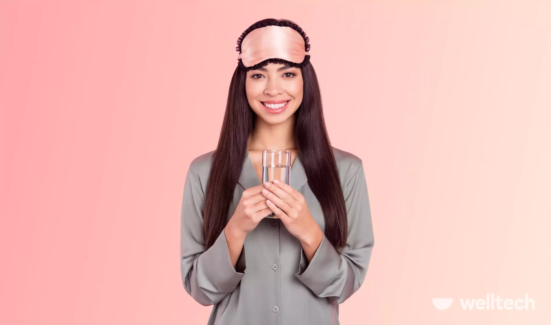 a woman is wearing sleeping mask, holding a glass of cold water, smiling, drinking ice water before bed