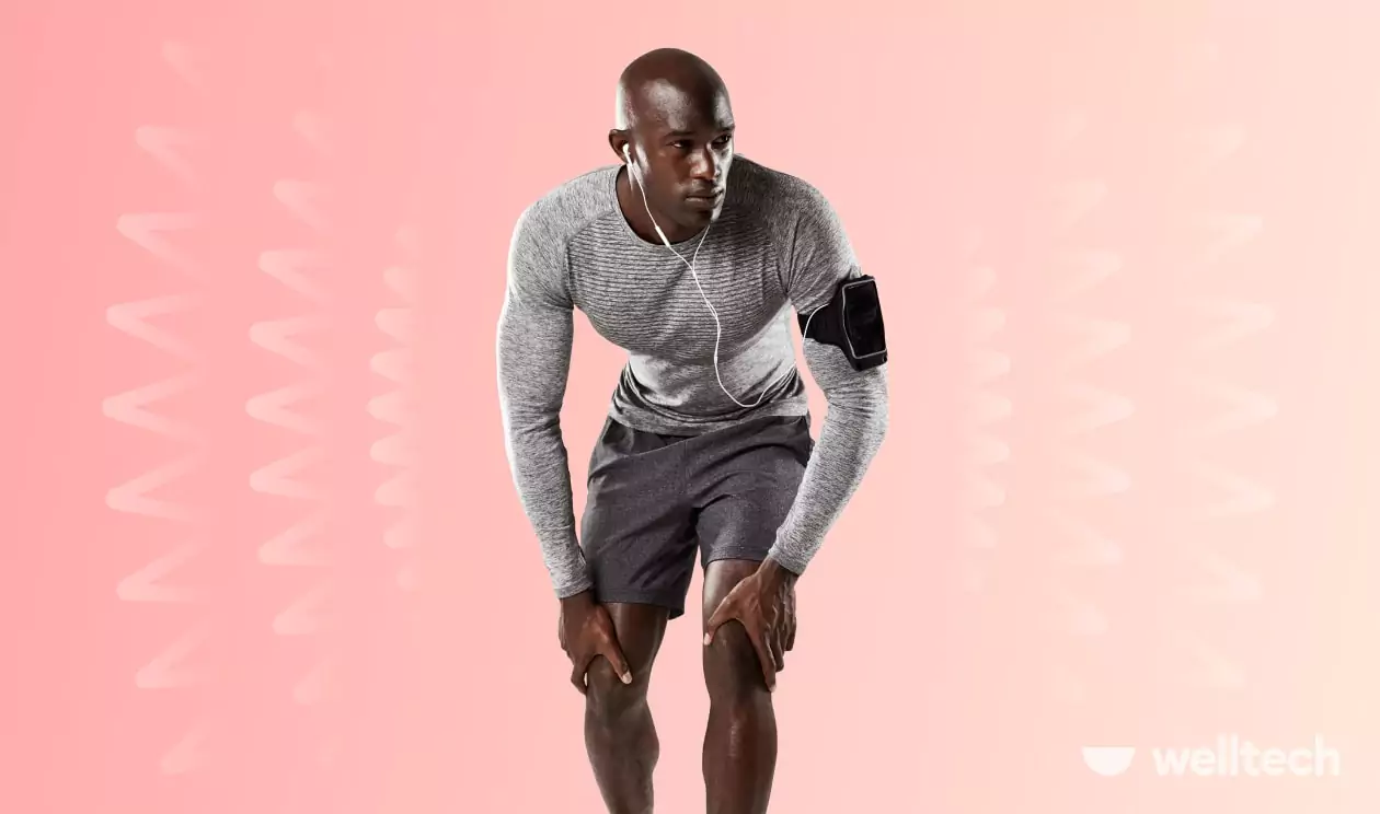 a man is working out, leaning on his legs, shaky legs after a workout