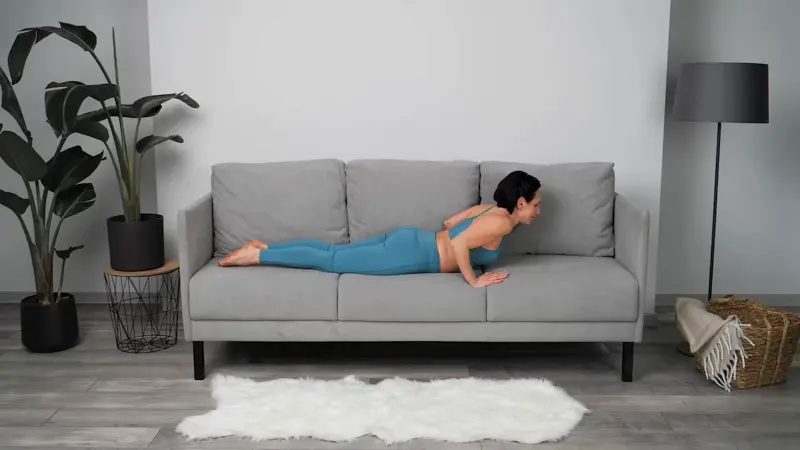 a woman is doing yoga in bed_sofa yoga_practicing Pigeon Pose