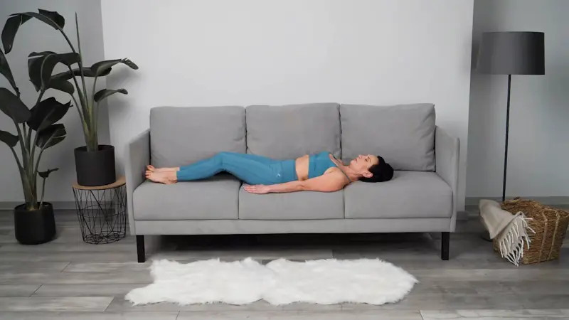 a woman is doing yoga in bed_sofa yoga_practicing Shoulder Bridge Pose