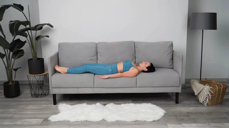 a woman is doing yoga in bed_sofa yoga_practicing Supine Easy Pose