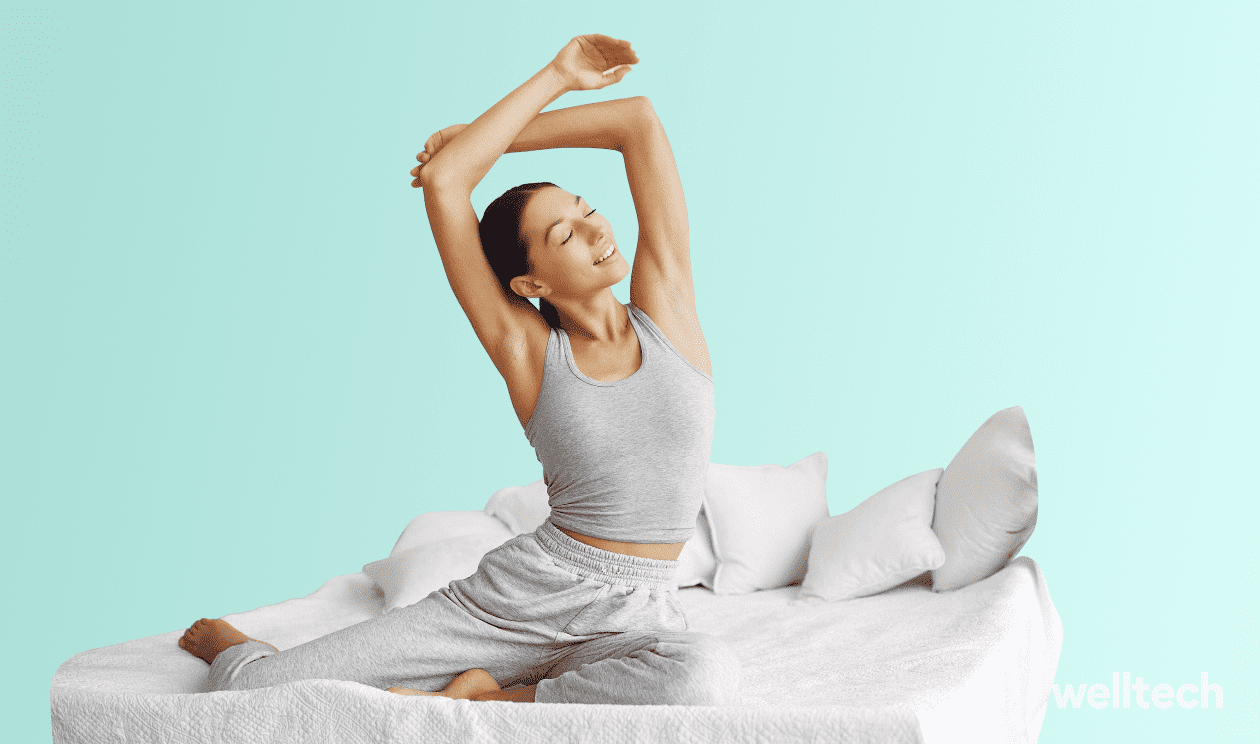 a young woman is stretching her back while in her bed, yoga in bed, bed yoga