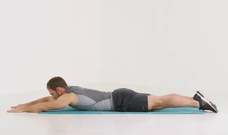 a man is working out, doing Contralateral Limb Raises_back exercises without weights