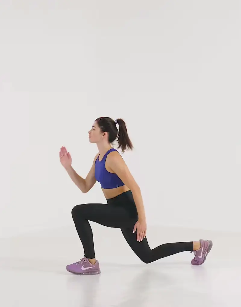 a woman is performing cardio legs workout, doing Reverse Lunge Jumps