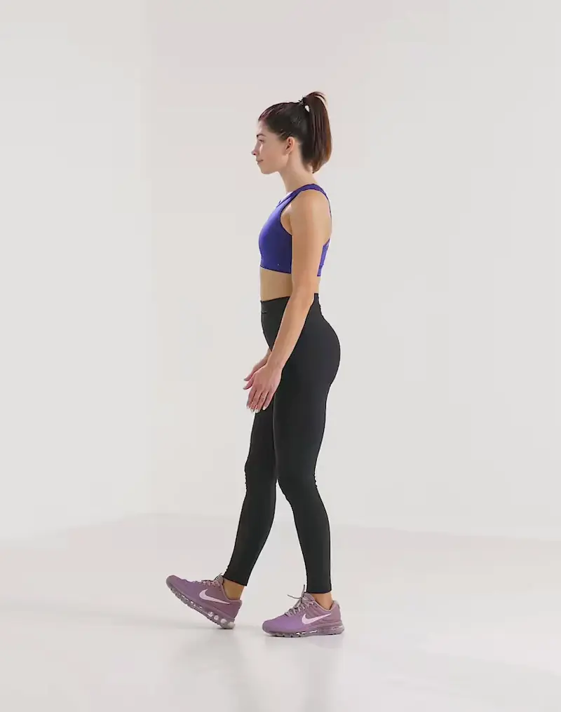 a woman is performing cardio legs workout, doing dynamic hamstring stretches