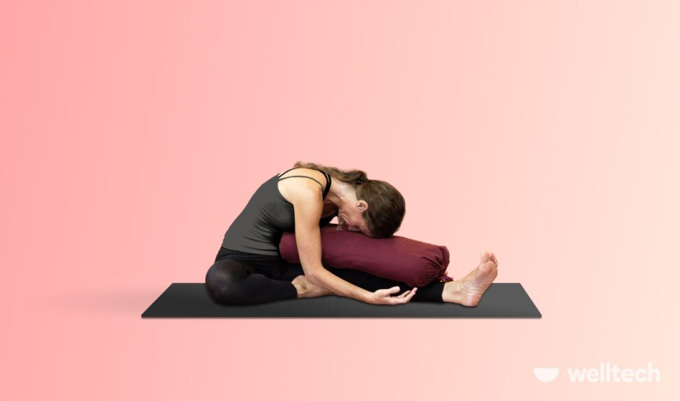 a woman is practicing yoga, doing seated head to knee forward fold_yoga for period cramps