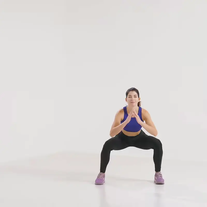 a woman is working out, doing side jump to squat_how to lose weight in thighs and butt