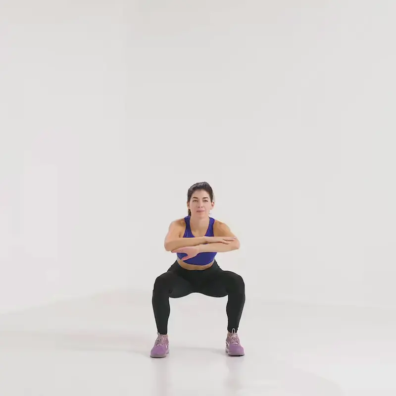 a woman is working out, doing squat jump_how to lose weight in thighs and butt